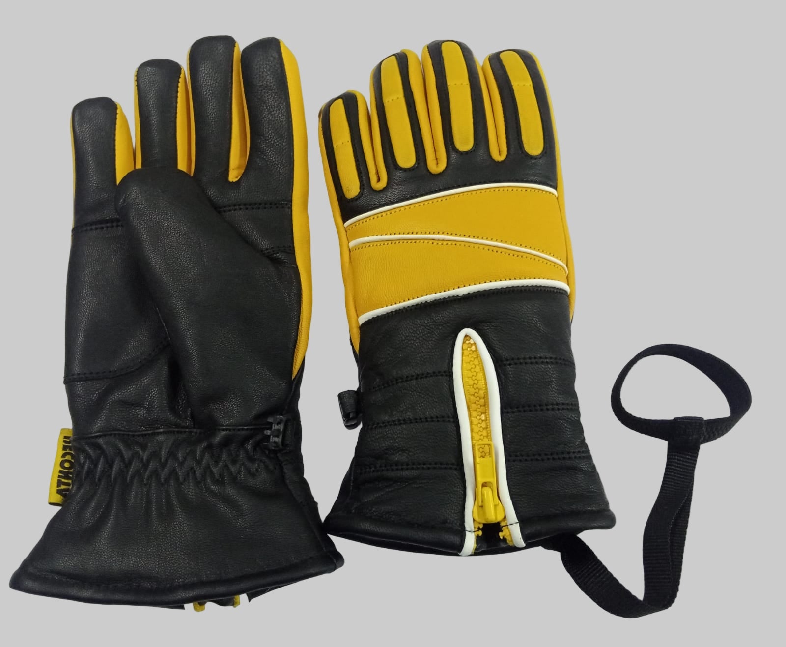 Black and yellow gloves with a strap on a white background