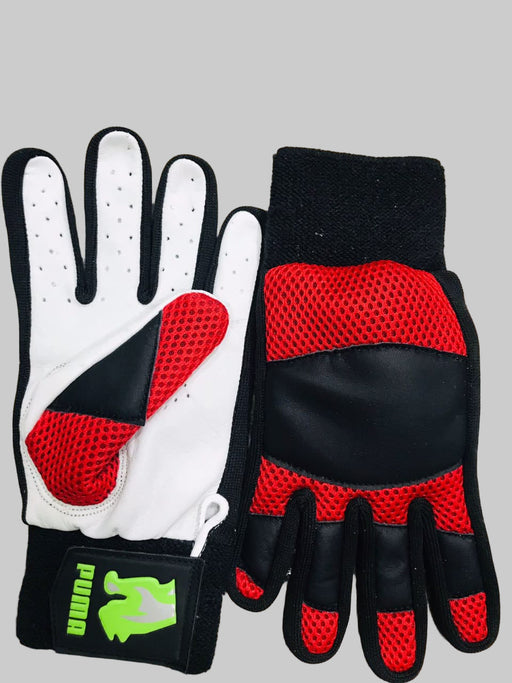 Pair of black and white gloves with red accents on a wooden floor.