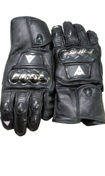 Pair of black motorcycle gloves with brand logos on a checkered background