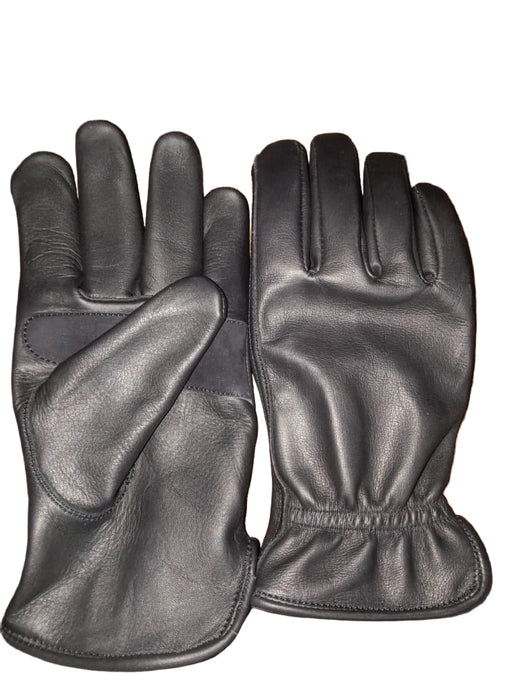 Pair of black leather gloves on a wooden surface
