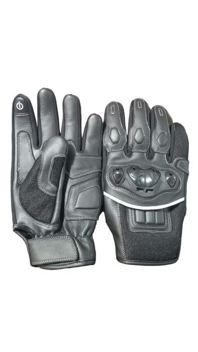 Pair of black motorcycle gloves on a textured surface