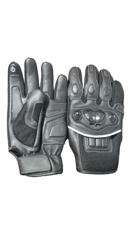 Pair of black motorcycle gloves on a textured surface