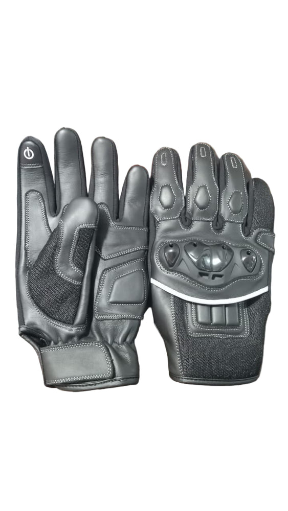 Pair of black motorcycle gloves on a textured surface